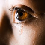 close-up photo of human eye with tear drops