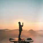 silhouette of praying man